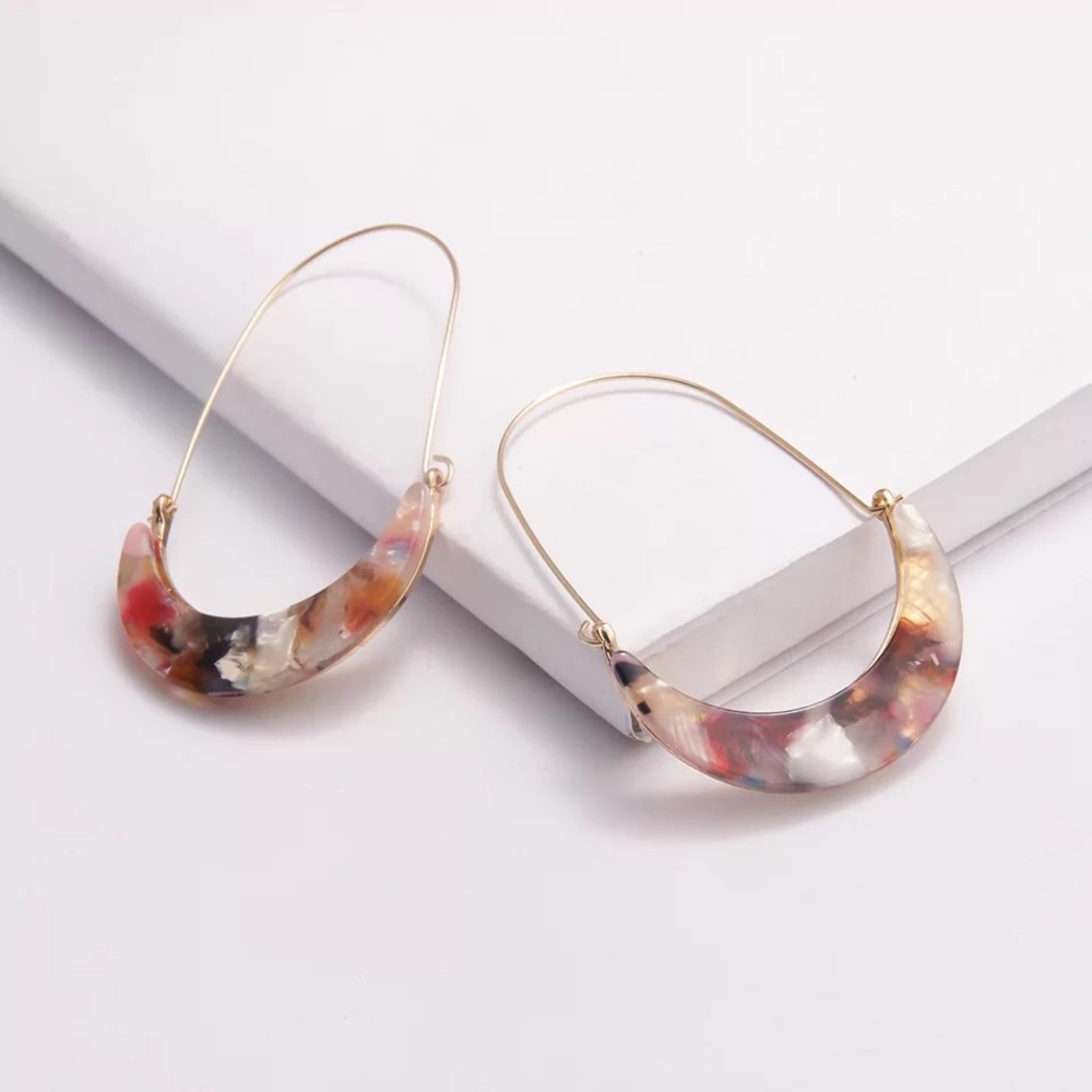 Multi-colored acetate/wire crescent hoop earrings.